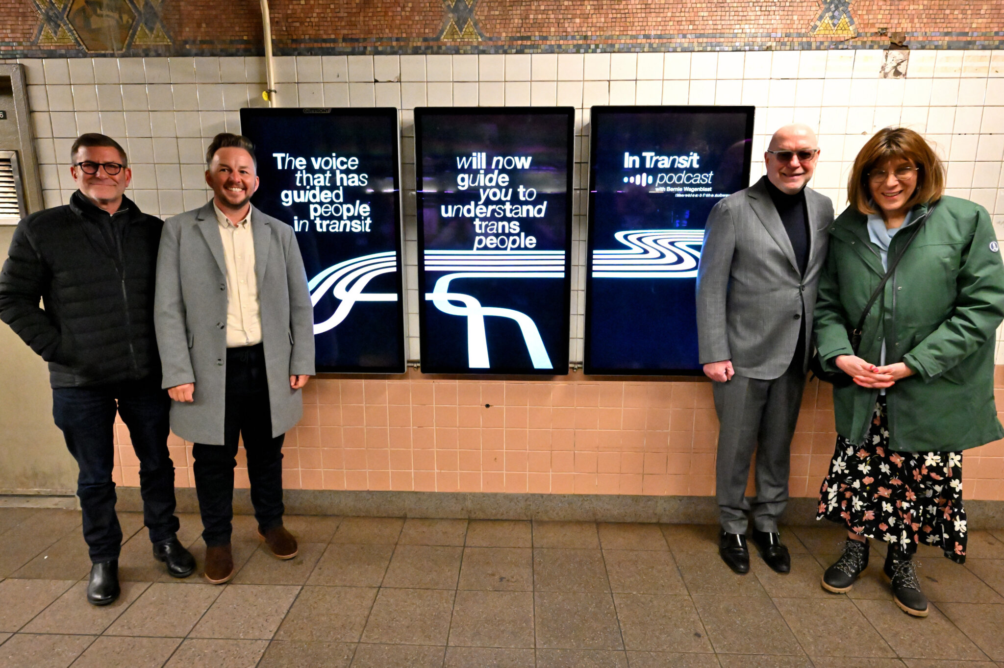 Ken Lustbader, Finn Brigham and Patrick McGovern, Bernie Wagenblast pose with billboard